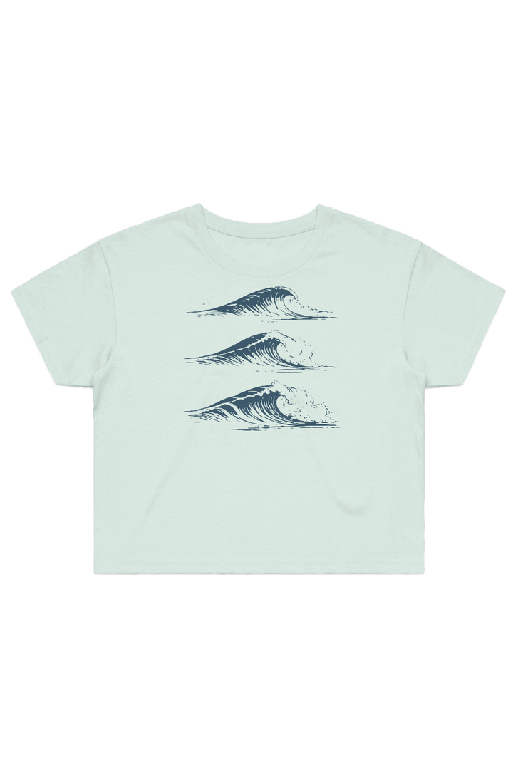 Drift Studies women's cropped tee in Seafoam with three navy coastal-wave illustrations on the front